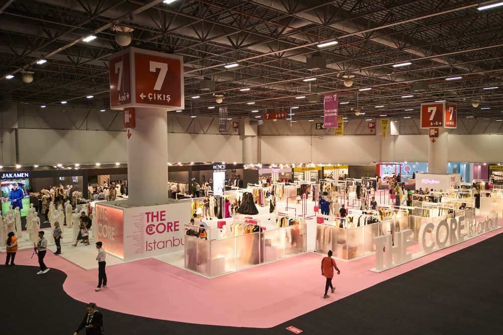 Fashion exhibition hall with visitors and brand displays